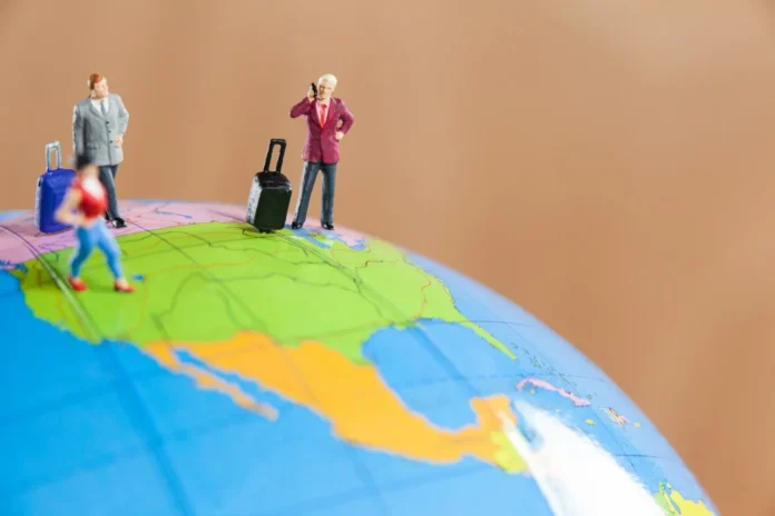 Dominica vs. St Kitts Citizenship by Investment Programs - A Global Perspective Miniature figures on a globe representing Caribbean Citizenship by Investment programs, comparing Dominica and St Kitts.