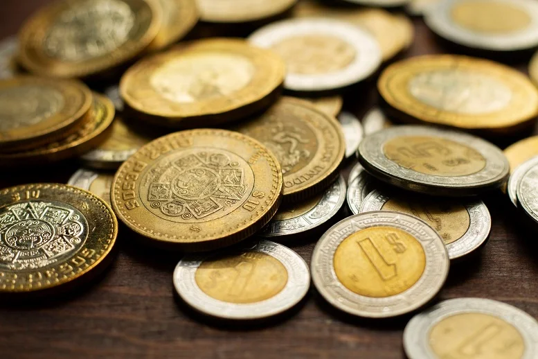 Close-up of diverse gold and silver coins showcasing options for liquid investments in precious metals.