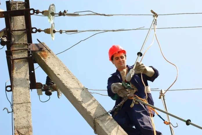 Portland State Electrician Leroy inspecting electrical panel at PSU campus