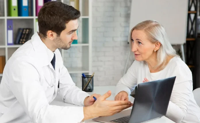 Healthcare advisor consulting with a senior woman in an office, emphasizing personalized medical guidance.