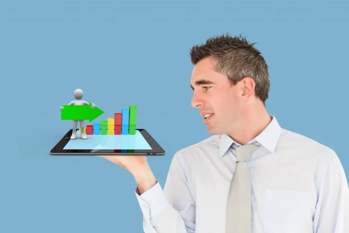 A business professional holding a tablet with a digital growth chart, representing how CodeBranch software solutions help businesses grow.