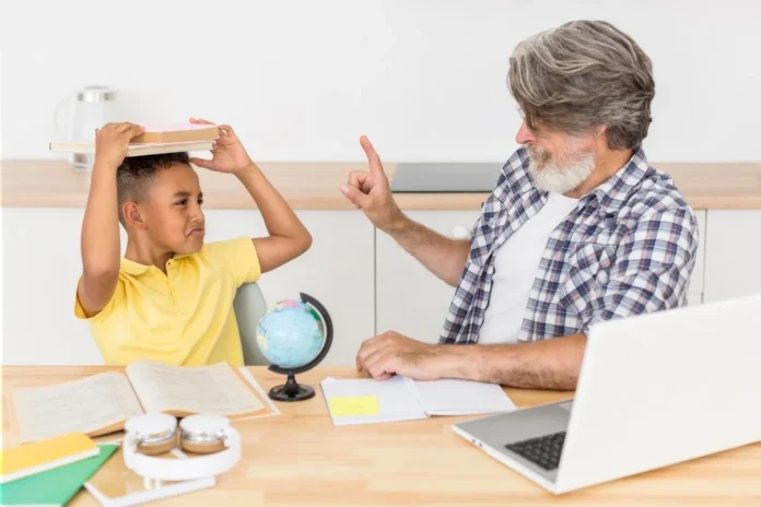 A frustrated child holding a book on his head while an older man points a finger, helping with homework meltdowns at home.
