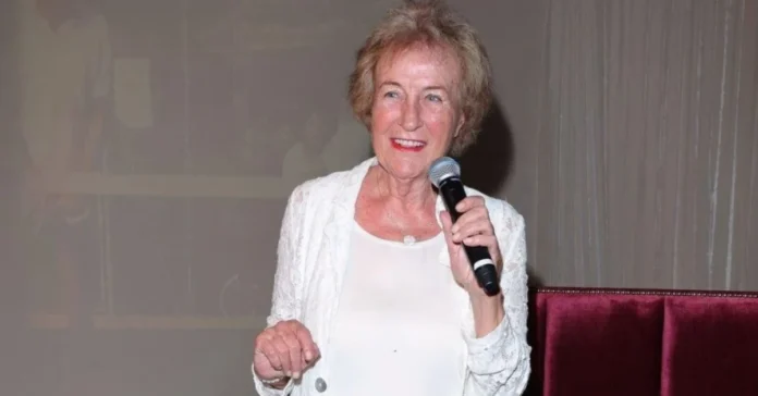 ursula kodjoe Ursula Kodjoe speaking at an event, wearing a white lace jacket and holding a microphone, symbolizing her influential and inspiring presence.